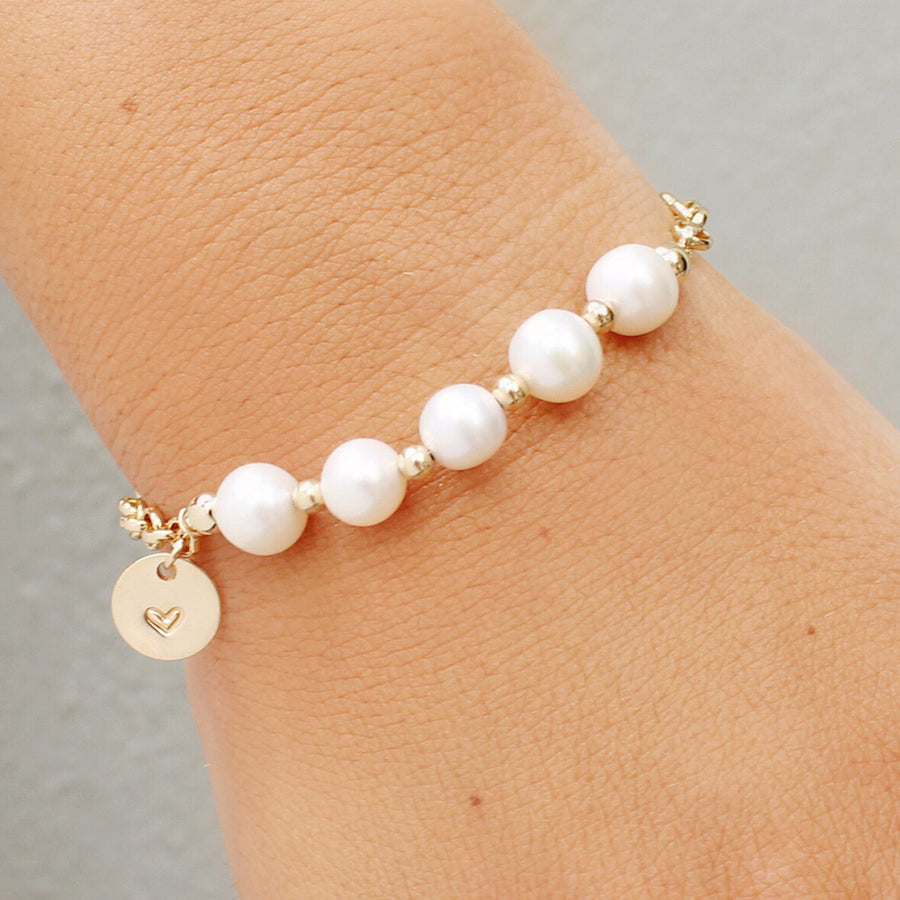 taudrey in a row pearl bracelet with multiple pearls and personalized gold charm