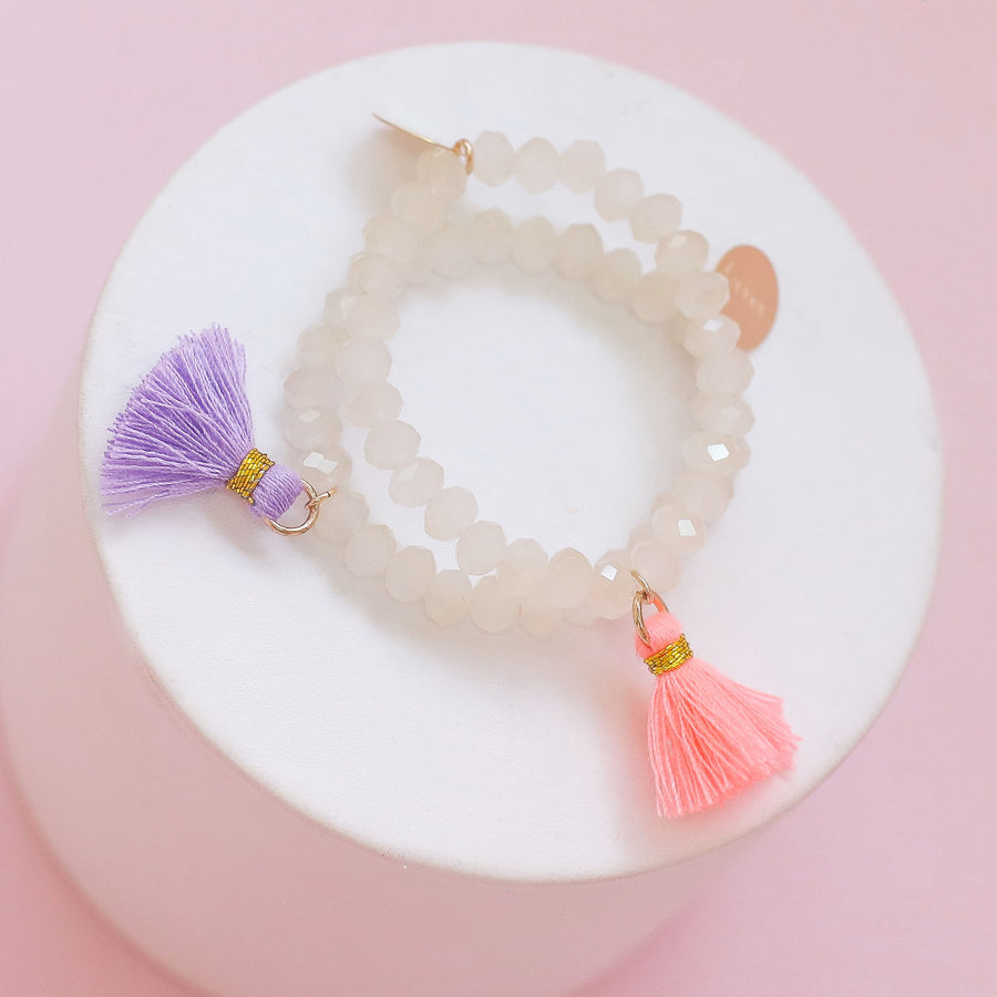 #33 Sample Kids beige beaded bracelet with pink or purple tassel
