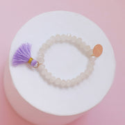 #33 Sample Kids beige beaded bracelet with pink or purple tassel