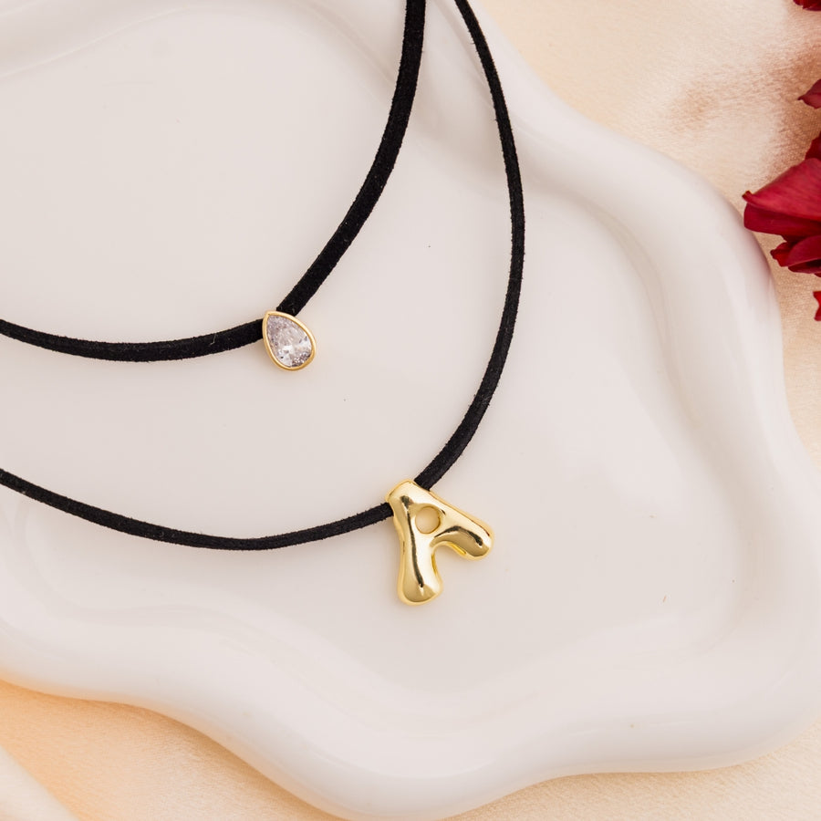 taudrey initial instinct necklace layered black cord