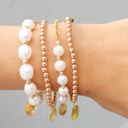 taudrey in a row pearl bracelet with multiple pearls and personalized gold charm